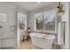Bright bathroom showcasing a soaking tub with shutters and light wood floors at 25 Summit Ash, Littleton, CO 80127