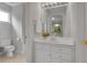 Clean bathroom with a white vanity, mirror, and tiled floor at 25 Summit Ash, Littleton, CO 80127