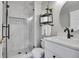 Bathroom with modern tile shower, storage shelves, and vanity at 25 Summit Ash, Littleton, CO 80127