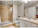 Bathroom featuring a walk-in shower with glass door, tile surround, and vanity at 25 Summit Ash, Littleton, CO 80127