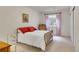 Bright bedroom featuring an upholstered bed, dresser, and window with red gingham curtains at 25 Summit Ash, Littleton, CO 80127