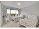 Neutral bedroom with two beds and a rocking chair at 25 Summit Ash, Littleton, CO 80127
