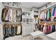 Organized walk-in closet featuring ample shelving, drawers, and clothing racks at 25 Summit Ash, Littleton, CO 80127