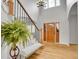 Bright entryway features hardwood floors, staircase with iron railings, and large windows for ample natural light at 25 Summit Ash, Littleton, CO 80127