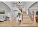 Elegant foyer with hardwood floors, a staircase with black iron railings, and a view into the living room at 25 Summit Ash, Littleton, CO 80127