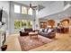 Bright living room with high ceilings, large windows, hardwood floors, and stylish furniture at 25 Summit Ash, Littleton, CO 80127