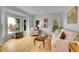 Cozy living room featuring hardwood floors, large windows with outside views, and comfortable seating at 25 Summit Ash, Littleton, CO 80127