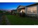 Green backyard with a fenced perimeter, lush lawn, and a charming patio area with a hot tub at 22065 E Bailey Pl, Aurora, CO 80016