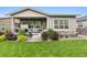 Spacious backyard showcasing the patio area with a hot tub and lush greenery at 22065 E Bailey Pl, Aurora, CO 80016