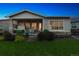 Beautifully landscaped backyard featuring a patio, hot tub, and lush lawn at 22065 E Bailey Pl, Aurora, CO 80016
