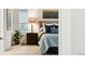 Inviting bedroom featuring a bed with a padded headboard, a nightstand, and a plant near the window at 22065 E Bailey Pl, Aurora, CO 80016