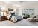 Bright bedroom with shuttered windows, comfortable seating, and a bed with a padded headboard at 22065 E Bailey Pl, Aurora, CO 80016