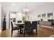 Bright dining room featuring modern lighting, wood floors, and easy access to the kitchen at 22065 E Bailey Pl, Aurora, CO 80016