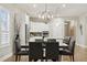 Dining area adjacent to the kitchen, featuring modern lighting and hardwood floors at 22065 E Bailey Pl, Aurora, CO 80016