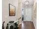 Inviting entryway featuring hardwood floors, modern light fixture and stylish decor at 22065 E Bailey Pl, Aurora, CO 80016
