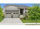Charming home featuring a two-car garage, stone accents, covered porch and manicured front lawn at 22065 E Bailey Pl, Aurora, CO 80016