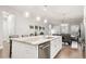 Kitchen with a large island, stainless appliances, and open layout to dining area at 22065 E Bailey Pl, Aurora, CO 80016