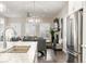 Well-lit kitchen opening to the dining and living area with modern finishes at 22065 E Bailey Pl, Aurora, CO 80016