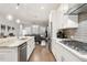 Open-concept kitchen with island, stainless steel appliances, and hardwood floors at 22065 E Bailey Pl, Aurora, CO 80016