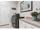 Convenient laundry room with modern washer, dryer, countertops, and storage at 22065 E Bailey Pl, Aurora, CO 80016