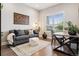 Cozy living room featuring a comfortable sofa, natural light, and stylish decor at 22065 E Bailey Pl, Aurora, CO 80016