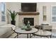 Stylish living room features a stone fireplace, layered tables, and a comfortable, neutral color palette at 22065 E Bailey Pl, Aurora, CO 80016