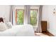 Bright bedroom with large windows, hardwood floors, and traditional radiator at 1220 S Vine St, Denver, CO 80210
