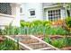 Beautifully landscaped front yard with stone steps and vibrant spring flowers at 1220 S Vine St, Denver, CO 80210