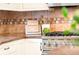 Close-up of updated kitchen featuring granite countertops, stainless steel appliances, and stylish tile backsplash at 1220 S Vine St, Denver, CO 80210