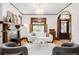 Stylish living room featuring a fireplace, hardwood floors, and elegant light fixtures at 1220 S Vine St, Denver, CO 80210