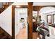 View of the original dark wood trim separating the living room from the updated kitchen and dining room at 1220 S Vine St, Denver, CO 80210