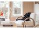 Relaxing living room featuring a comfortable chair and natural light at 1220 S Vine St, Denver, CO 80210