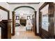 Elegant archway into a living room with hardwood floors and a fireplace at 1220 S Vine St, Denver, CO 80210
