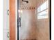 Updated shower with neutral tile, decorative accents, and glass door at 1220 S Vine St, Denver, CO 80210