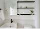 Modern bathroom with minimalist design, open shelving, and matte black fixtures at 1601 Park Ave # 214, Denver, CO 80218