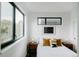 Bright bedroom with large windows, stylish pillows, and modern bedside tables at 1601 Park Ave # 214, Denver, CO 80218