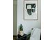 Cozy reading nook featuring modern art, a snake plant, a warm throw, and stylish decor at 1601 Park Ave # 214, Denver, CO 80218