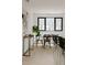Bright dining area with modern black chairs, wood table, a large window, and stylish decorations at 1601 Park Ave # 214, Denver, CO 80218