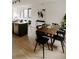 Inviting living and dining space with modern decor, island seating, and a charming wood table at 1601 Park Ave # 214, Denver, CO 80218