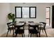Cozy dining room with a wooden table, black chairs, large window, and neutral decor at 1601 Park Ave # 214, Denver, CO 80218