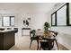 Elegant dining area with modern art and large windows, perfect for entertaining and Gathering meals at 1601 Park Ave # 214, Denver, CO 80218