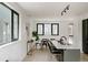 Open-concept living space with dining area, featuring an island with seating and modern black accents at 1601 Park Ave # 214, Denver, CO 80218