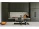 Modern kitchen featuring sleek, dark cabinetry, stainless steel appliances, and a bright countertop at 1601 Park Ave # 214, Denver, CO 80218