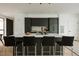 Modern kitchen with a large island, sleek black cabinets, and contemporary bar stools at 1601 Park Ave # 214, Denver, CO 80218