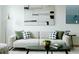 Cozy living room featuring a comfortable sofa, stylish decor, and natural light from the window at 1601 Park Ave # 214, Denver, CO 80218