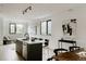 Spacious living room and dining area with modern lighting and elegant decor with black accents at 1601 Park Ave # 214, Denver, CO 80218