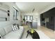 Open-concept living space with modern decor, flowing seamlessly into a sleek kitchen at 1601 Park Ave # 214, Denver, CO 80218