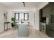 Bright living space seamlessly connecting the modern kitchen with stainless steel appliances and a sleek island at 1601 Park Ave # 214, Denver, CO 80218