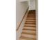 Bright staircase featuring wooden stairs and railings, providing access to upper levels at 1601 Park Ave # 214, Denver, CO 80218
