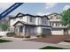 Charming two-story home featuring a covered porch, attached garage, and beautifully landscaped front yard at 1194 Sugarloaf Ln, Erie, CO 80516